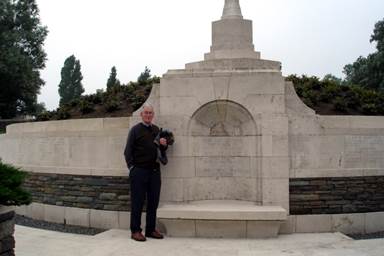 A person standing in front of a stone structure

Description automatically generated with low confidence